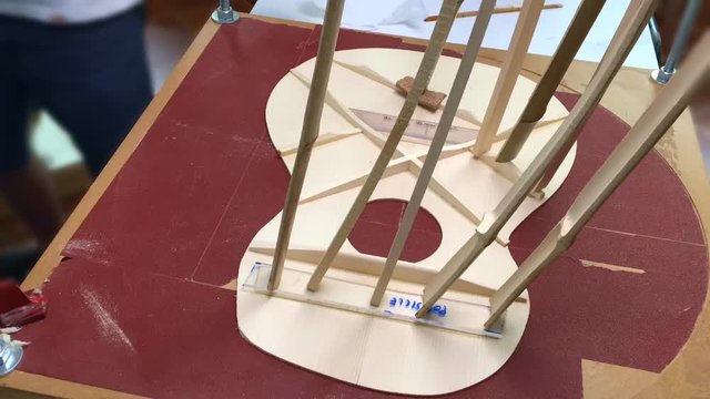 Time lapse of Making an acoustic guitar interior close up