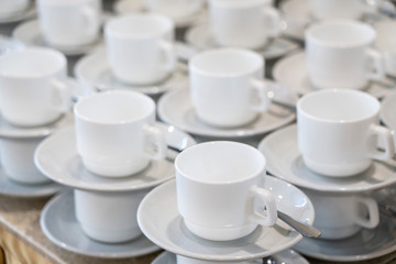 Serving white porcelain coffee and tea cups with saucer
