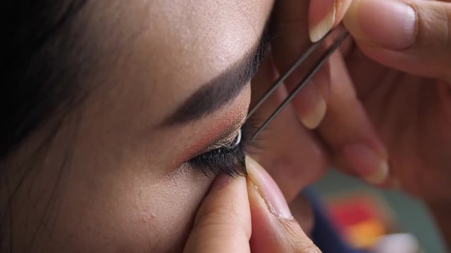slow motion, makeup beauty paste long false eyelash on eye