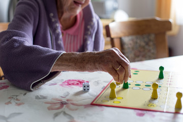 Senior woman playing ludo board game