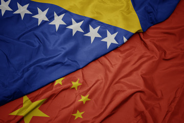 waving colorful flag of china and national flag of bosnia and herzegovina.