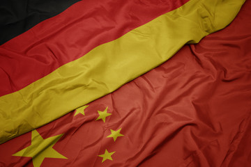 waving colorful flag of china and national flag of germany.