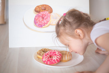 little girl eating doughnut