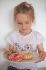 little girl eating doughnut