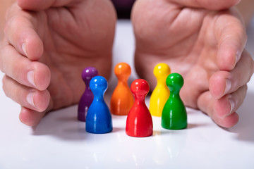 Person Protecting Multicolored Pawns