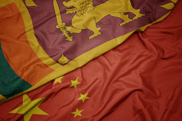 waving colorful flag of china and national flag of sri lanka.