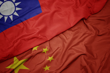 waving colorful flag of china and national flag of taiwan.