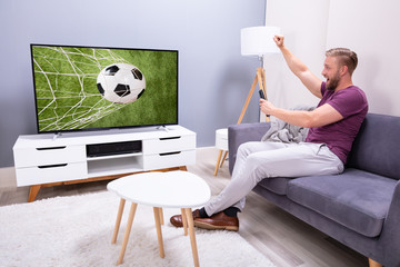 Woman Watching Soccer Game On Television