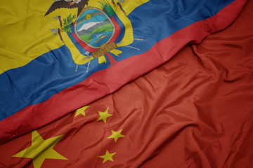 waving colorful flag of china and national flag of ecuador.