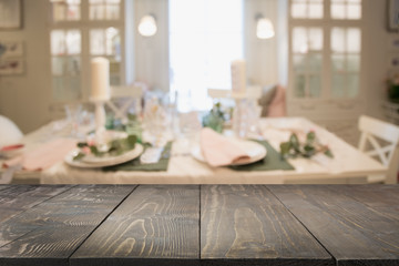 Wooden tabletop and blurred cafe as background. Space for you design and montage.
