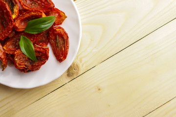 Sun dried tomatoes on wooden background