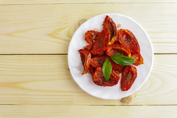 Sun dried tomatoes on wooden background