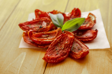 Sun dried tomatoes on wooden background