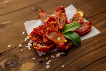 Sun dried tomatoes on wooden background
