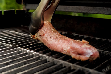 grilling pork meat. spices on meat.