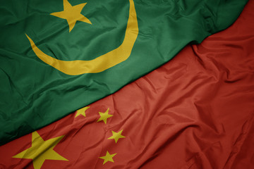 waving colorful flag of china and national flag of mauritania.