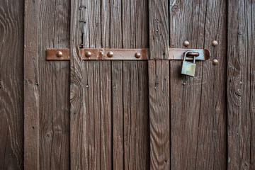 Brown wooden background texture with padlock. Vertical planks, bars