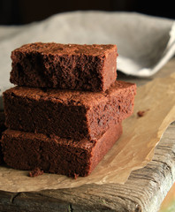 stack of baked square pieces of chocolate brownie cake