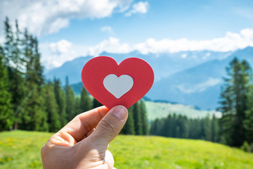 Person Holding Heart In Mountains