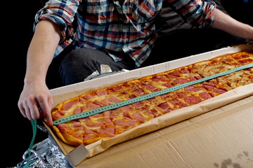 Measure pizza length with a tape measure