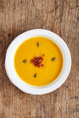 pumpkin cream soup on the wooden background