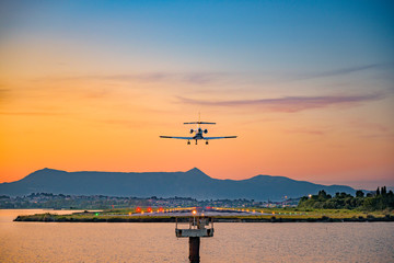 airplane landing during sunset