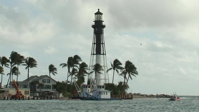 Lighthouse at Lighthouse Point Florida with palm trees seagulls and ocean on a sunny day