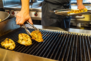 chef making grilled chicken breast