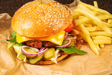 burger with french fries on parchment