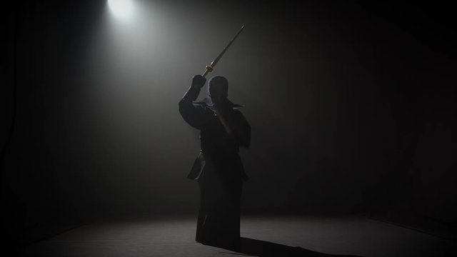Kendo instructor practicing martial art with the Katana sword.