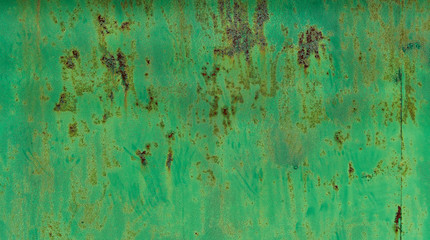 Peeling  green paint on old wall background texture.