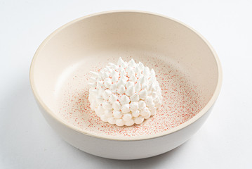 meringue with mango sauce on the white plate