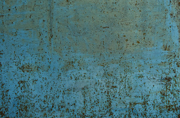 Rust stains on the metal surface. Rusted blue painted metal wall.