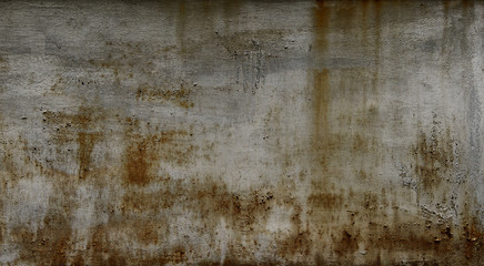 Gloomy grey wall with rust stains on the metal surface - background. Grunge wall.