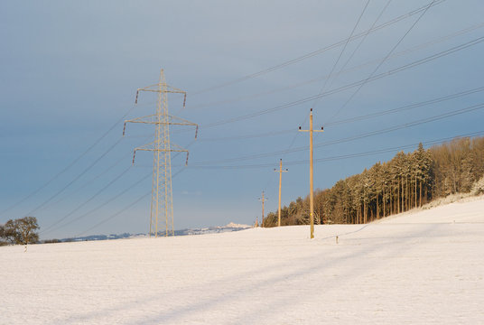 Electric Powerlines Crossing in a Winter Landscape - 20kV - Powerline crossing under a 380kV - Powerline - A Concept for the Transmission of Electic Energy