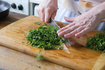 Sliced parsley and dill on board. Greens for the second course.