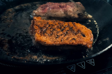 Slices of chicken breast in pan. Fried poultry meat.