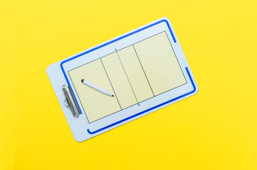 Volleyball tactical board with marker on yellow background. Top view