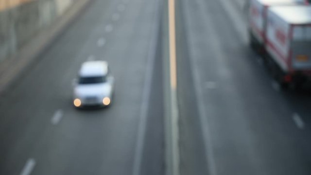 view of urban car traffic early in the morning, defocus makes beautiful bokeh from the included headlights, general plan
