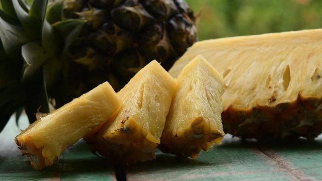 Slices Of Pineapple On Green Wood