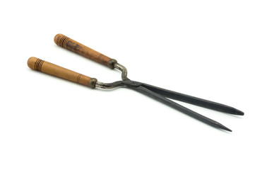 Antique vintage curling iron on white background