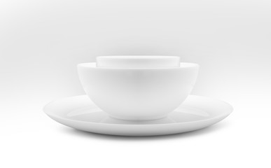 Set of white dishes on table on light background.