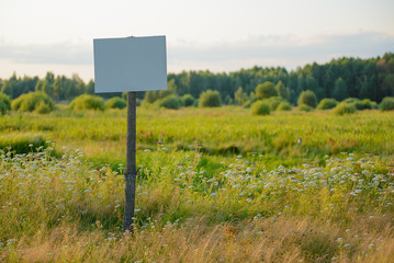 Sign on the nature near the forest on a sunny day