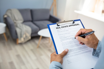 Man Filling Real Estate Appraisal Form