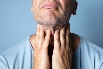 Close-up Of A Man Touching His Sore Throat