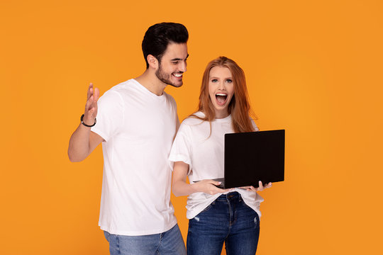 Happy youg couple posing together in studio.
