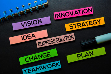 Vision, Innovation, Idea, Business Solution, Strategy, Change, Teamwork, Plan text on sticky notes isolated on Black desk. Mechanism Strategy Concept