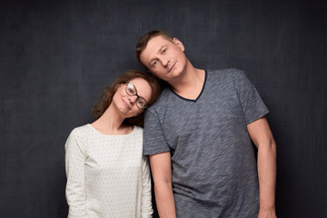 Portrait of man and woman tilting heads to each other