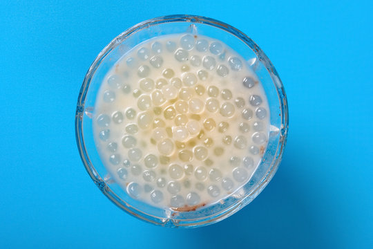 top view bowl of Chinese syrup of sago on blue background
