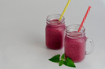 bilberry or blueberry smoothie in jar isolated on white background. Purple milkshake.